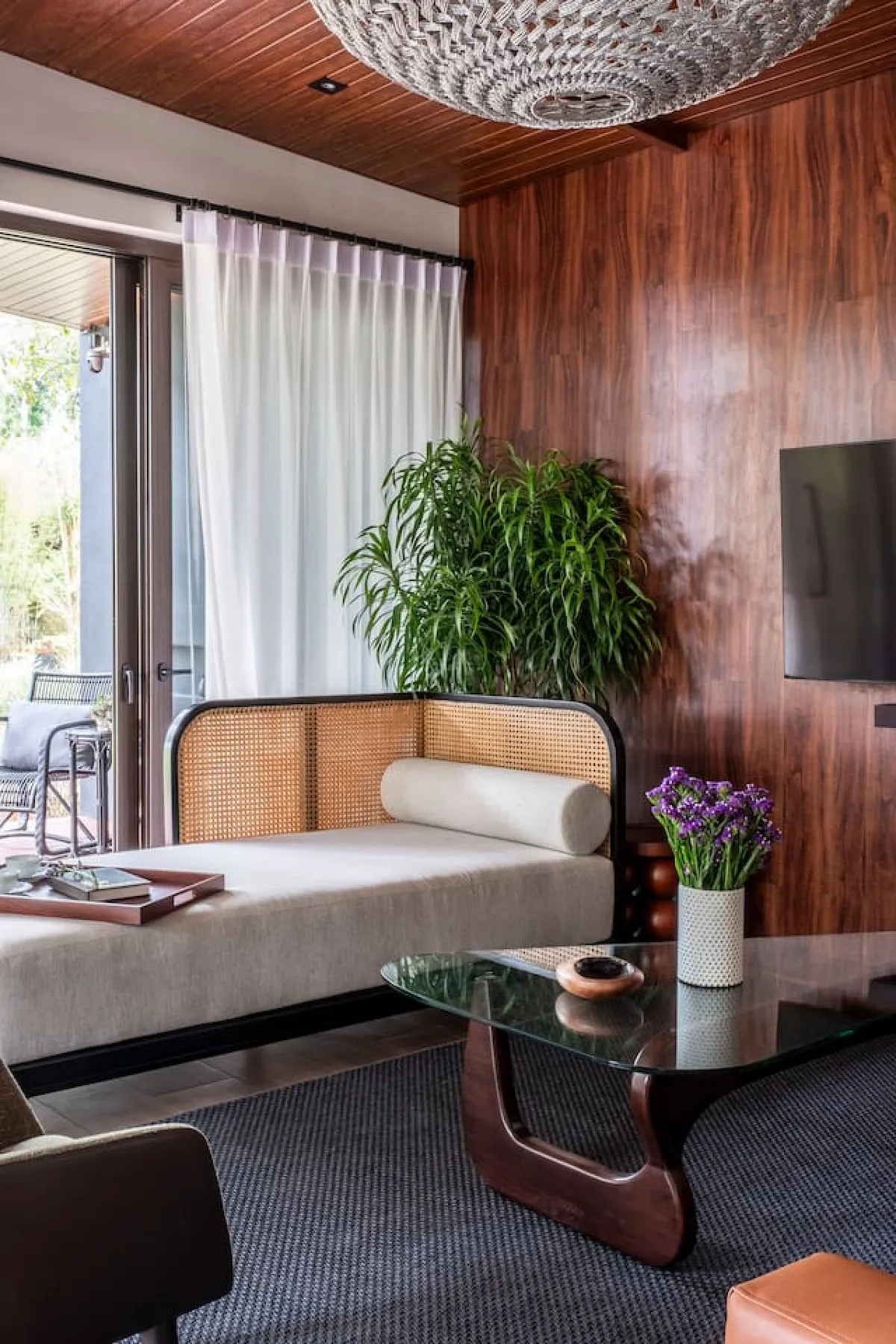 Ezra Viniti standard room with elegant wood paneling and modern furnishings